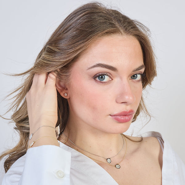 Gold-plated silver necklace with central disc and four-leaf clover