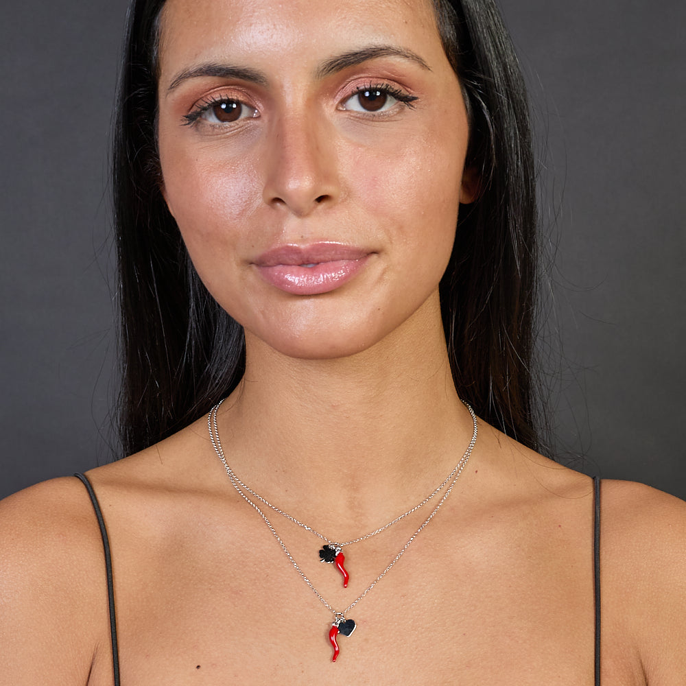 Rhodium-plated silver necklace with enameled horn centerpiece and heart pendants