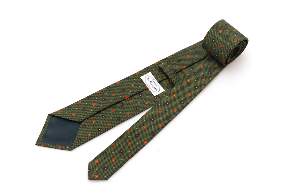 Green tie with geometric pattern in pure silk
