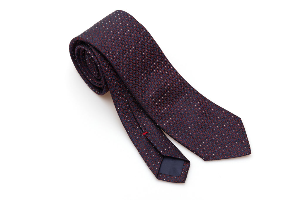 Blue tie with red geometries in pure silk