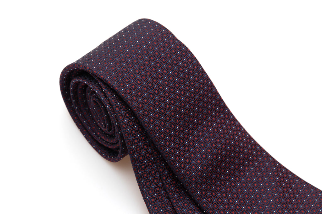 Blue tie with red geometries in pure silk