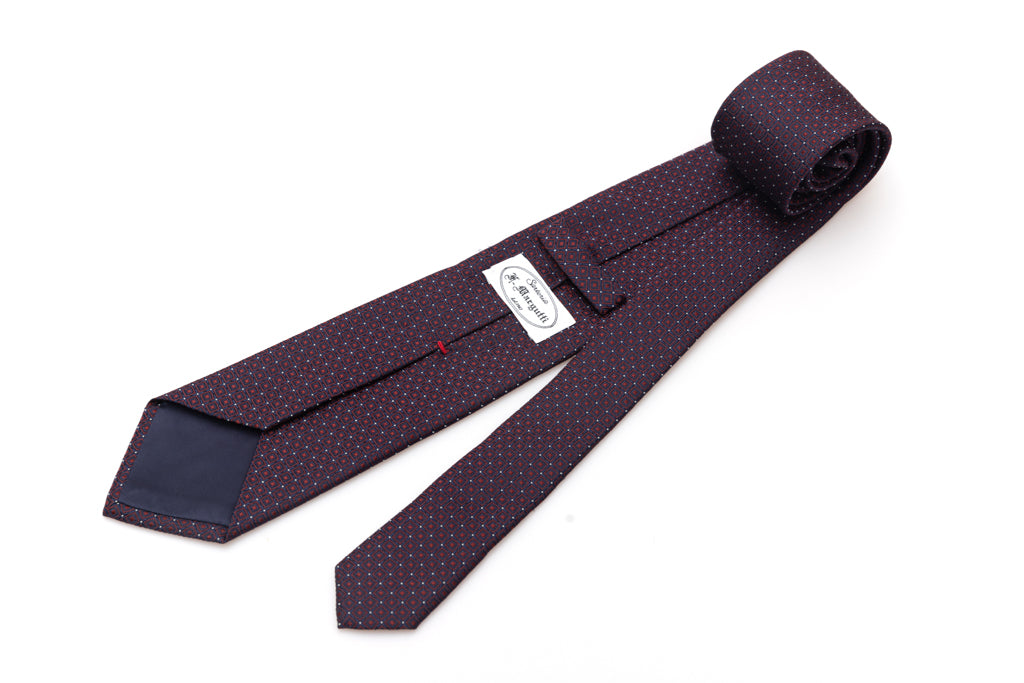 Blue tie with red geometries in pure silk