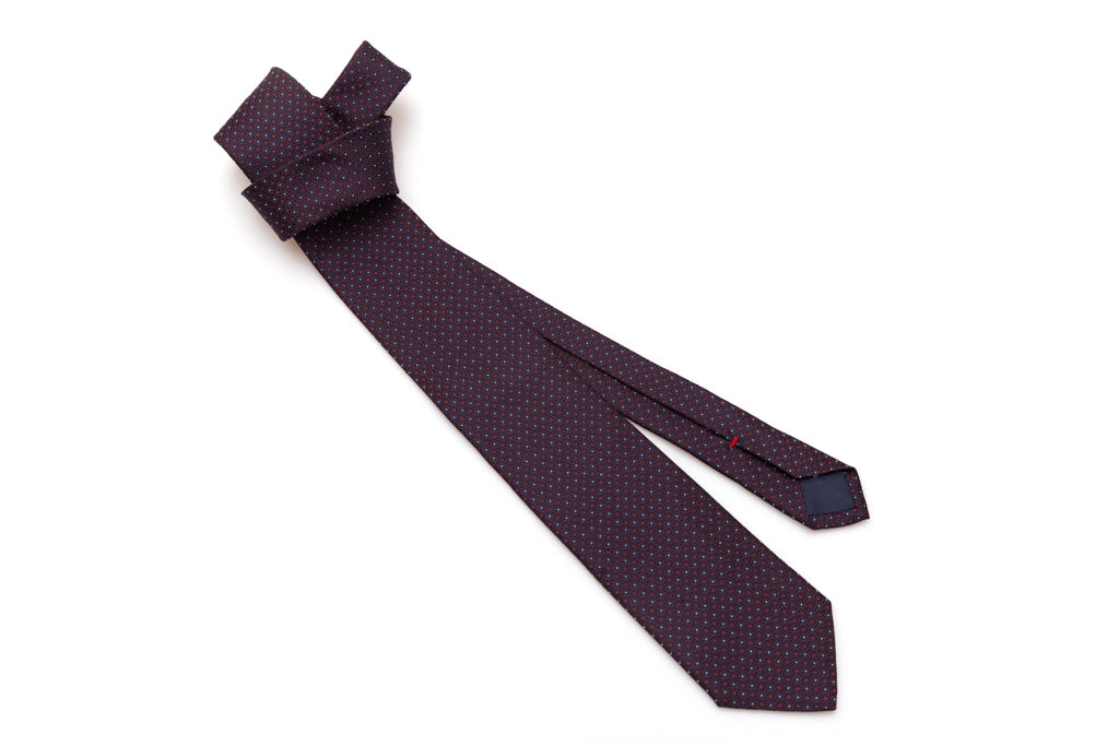 Blue tie with red geometries in pure silk