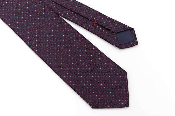 Blue tie with red geometries in pure silk