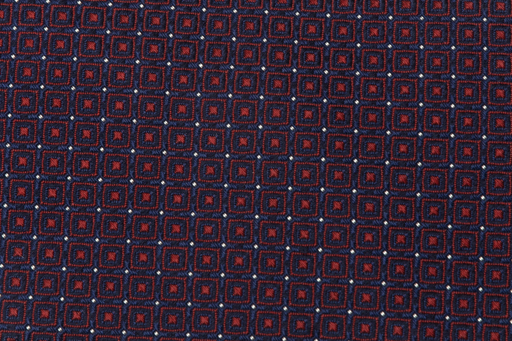 Blue tie with red geometries in pure silk