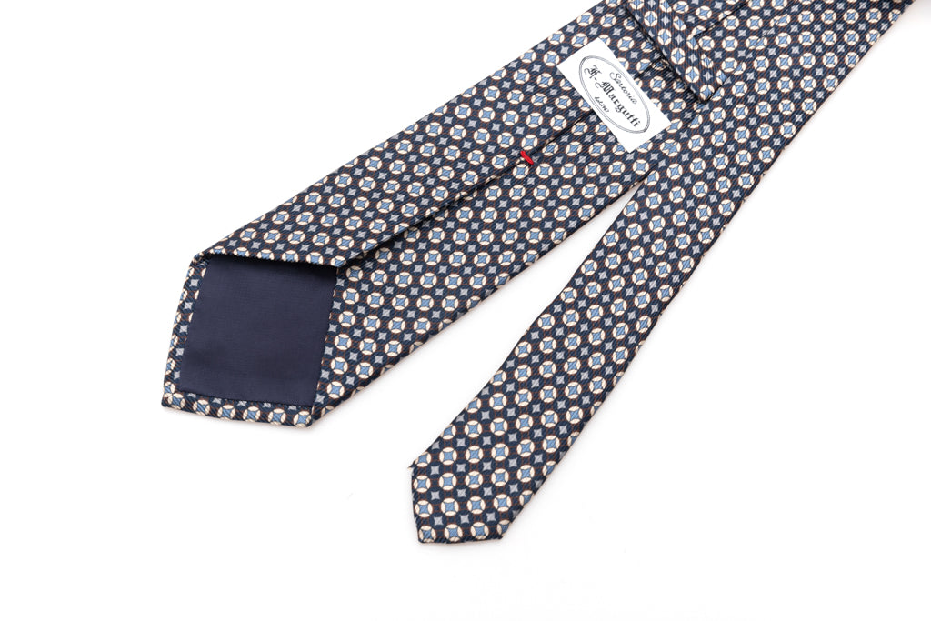 Blue tie with white and light blue geometry in pure silk