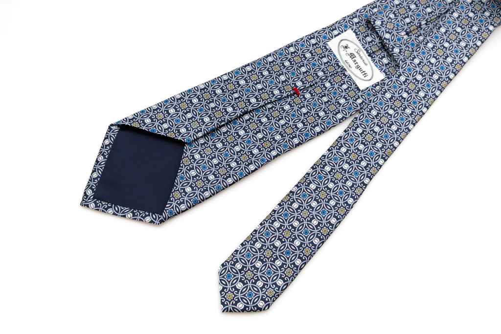 Blue tie with white geometric pattern 100% silk