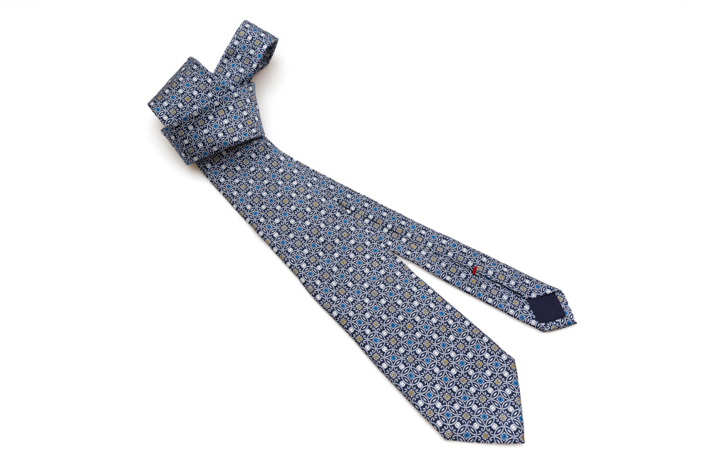 Blue tie with white geometric pattern 100% silk