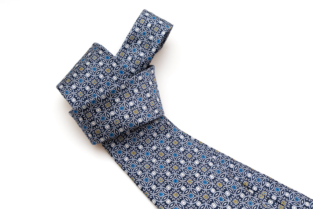 Blue tie with white geometric pattern 100% silk