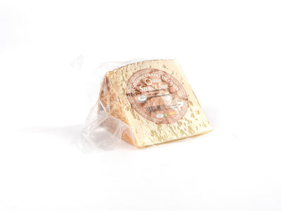 Semi-cured sheep cheese wedge
