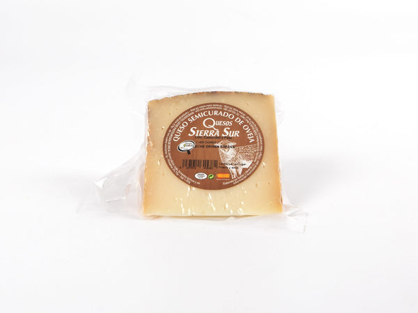 Semi-cured sheep cheese wedge