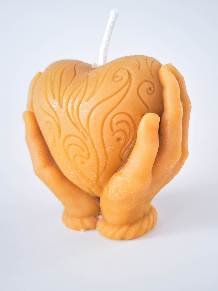 Candle heart in hands