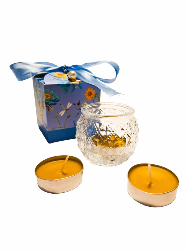 Tea candle in round glass in a box