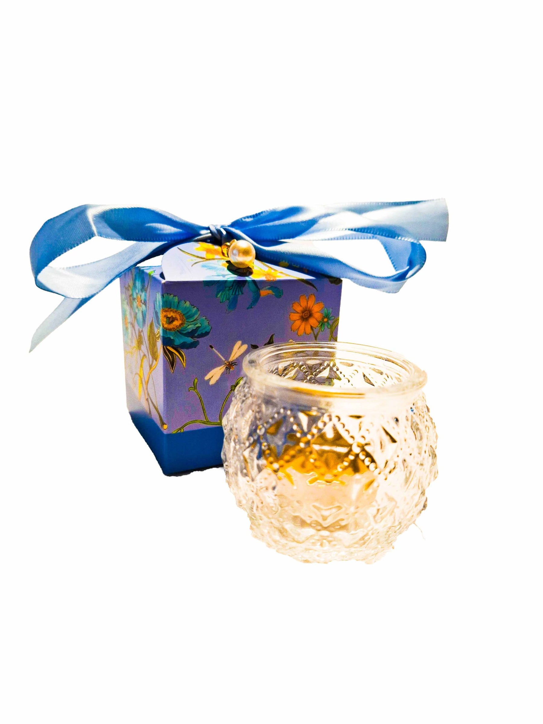 Tea candle in round glass in a box