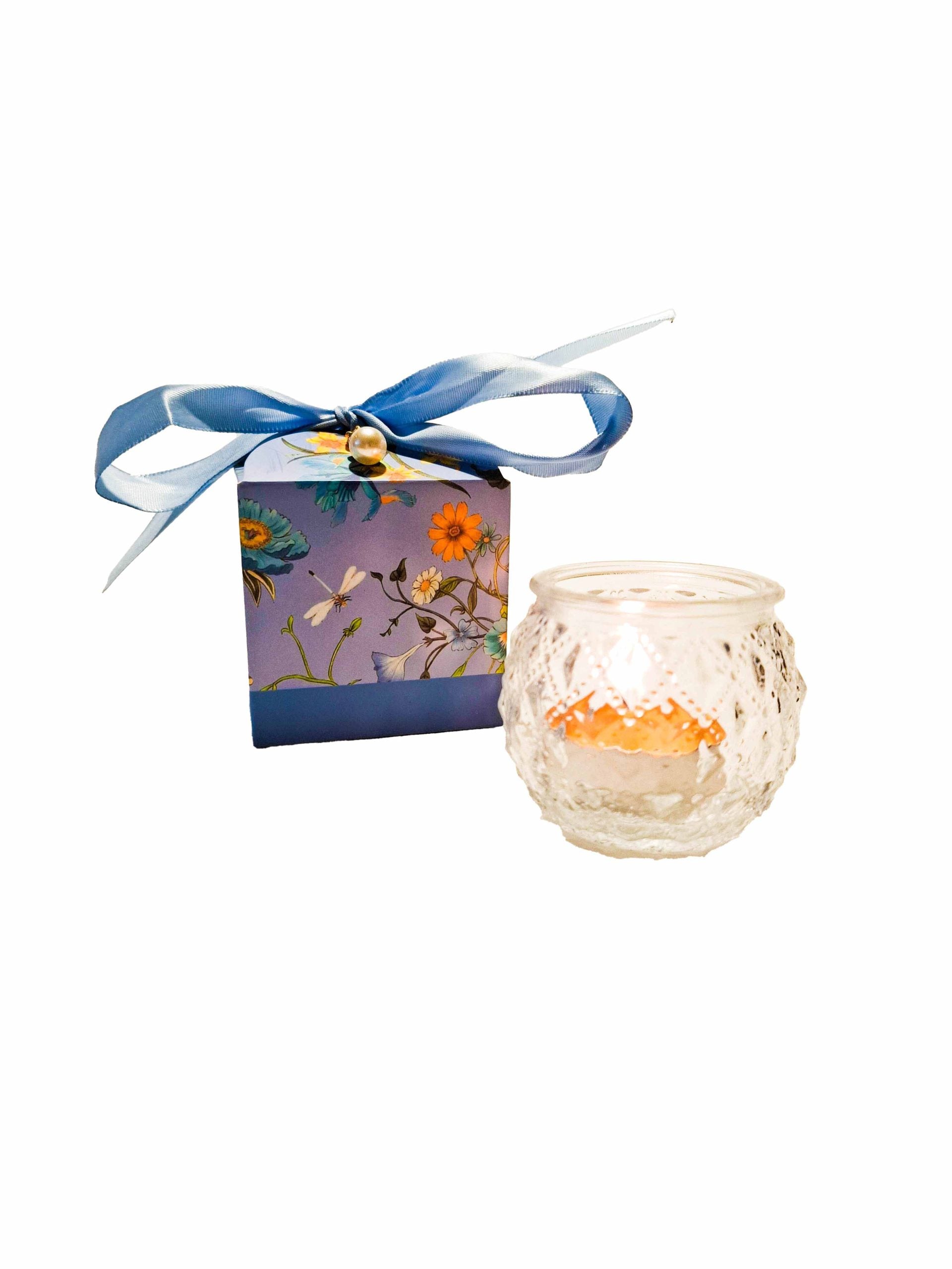 Tea candle in round glass in a box