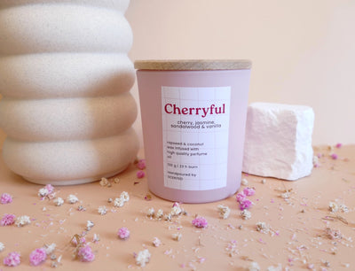 Naravna veganska dišeča sveča Cherryful v steklenem kozarcu z elegantno etiketo – zapeljiva aroma češnje in mandlja za romantično vzdušje.