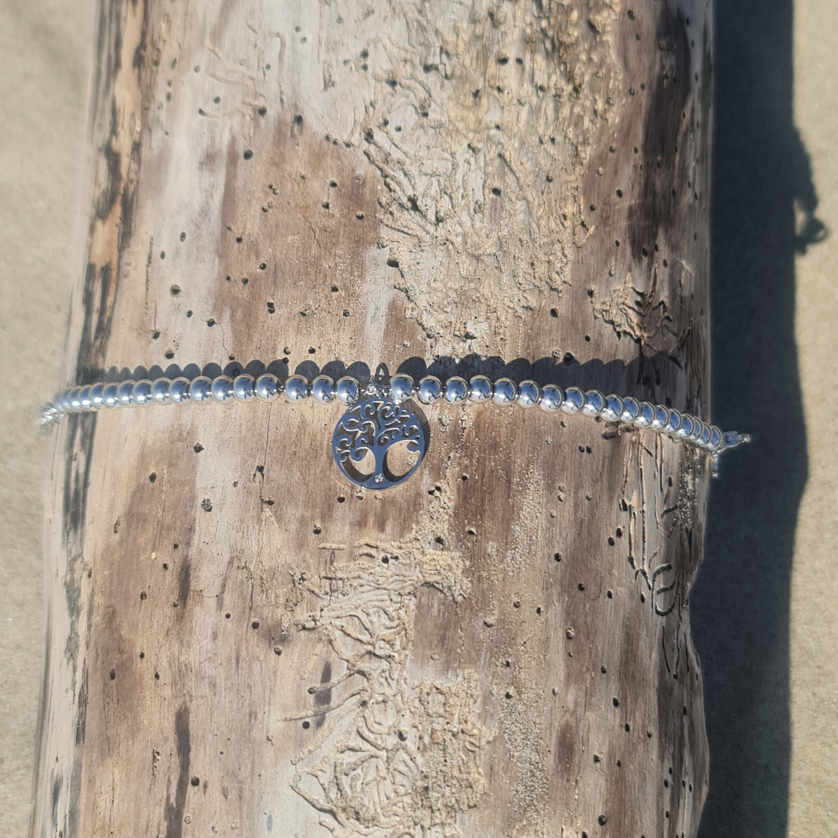 Bracelet in steel with shiny spheres and central pendant tree of life cut-out