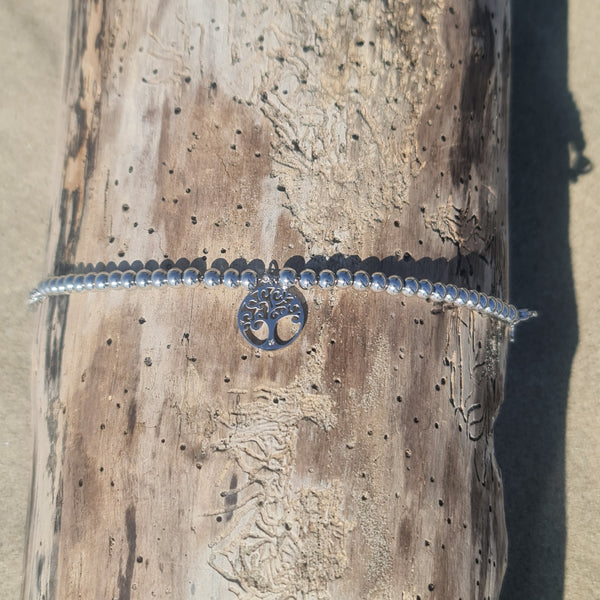 Bracelet in steel with shiny spheres and central pendant tree of life cut-out