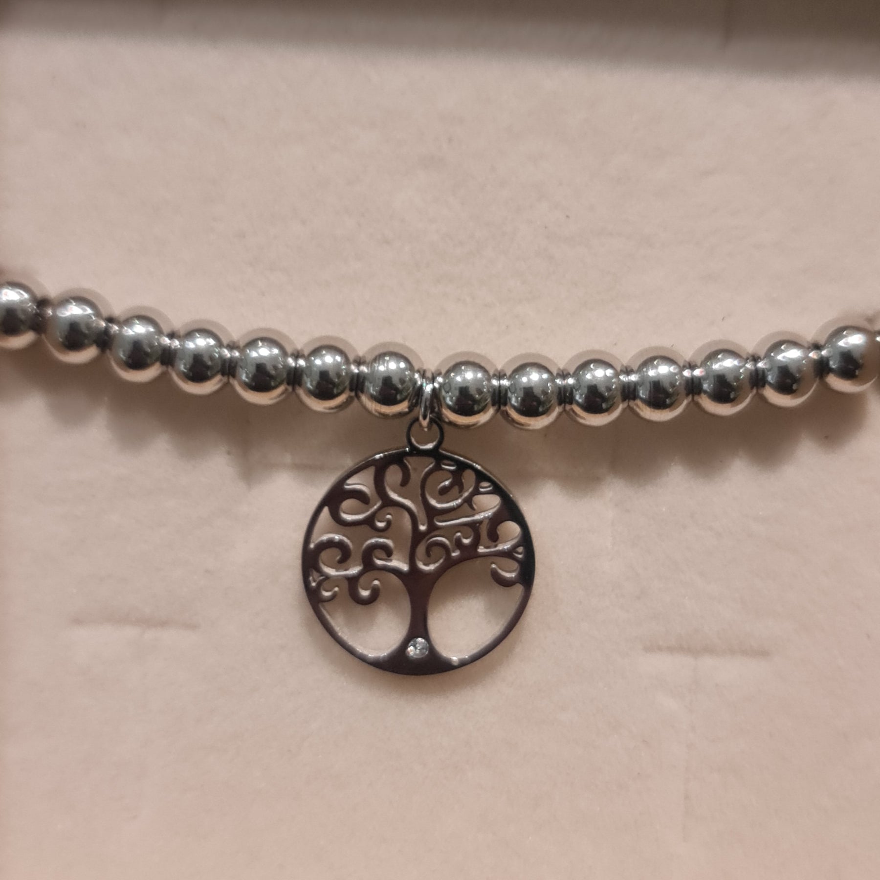 Bracelet in steel with shiny spheres and central pendant tree of life cut-out