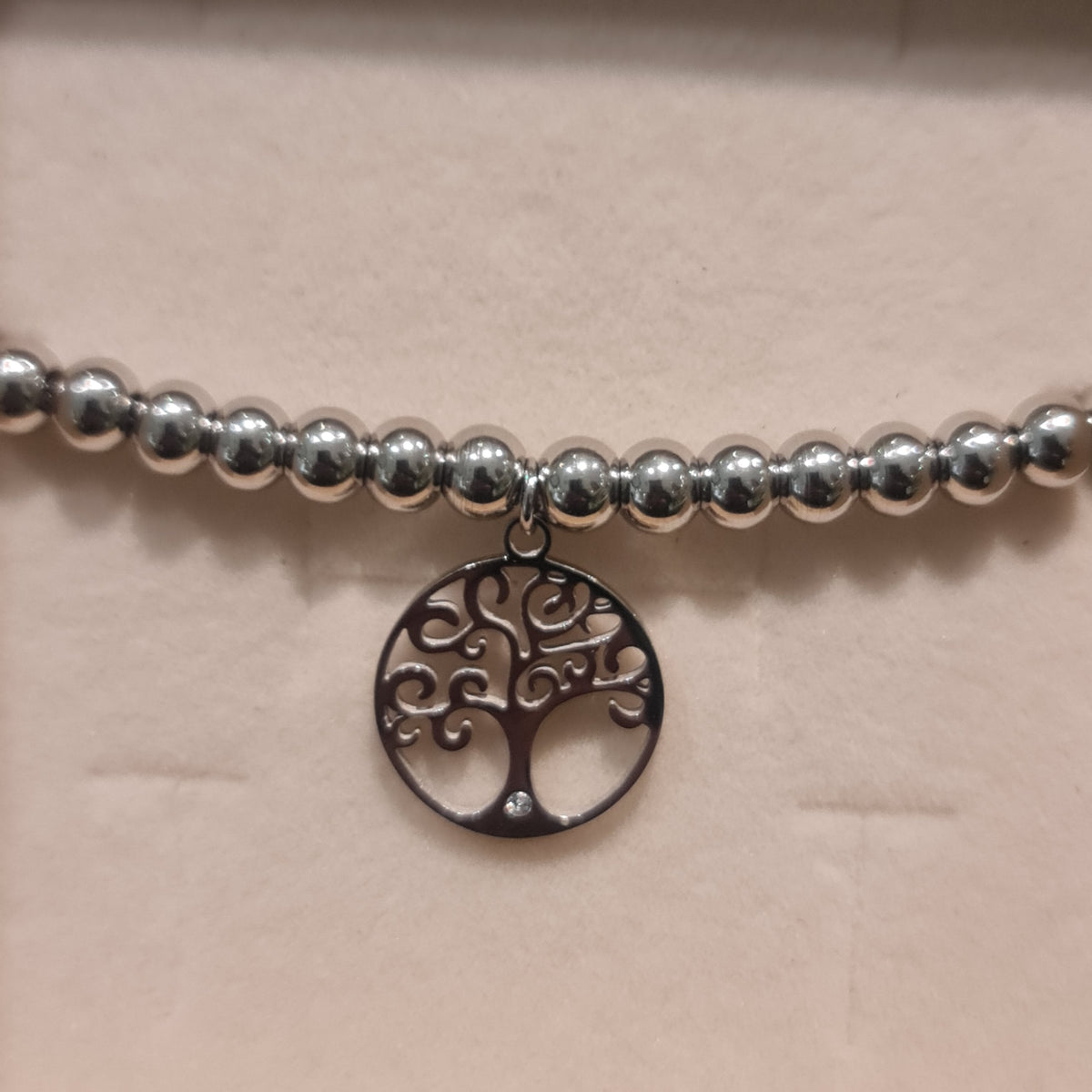 Bracelet in steel with shiny spheres and central pendant tree of life cut-out