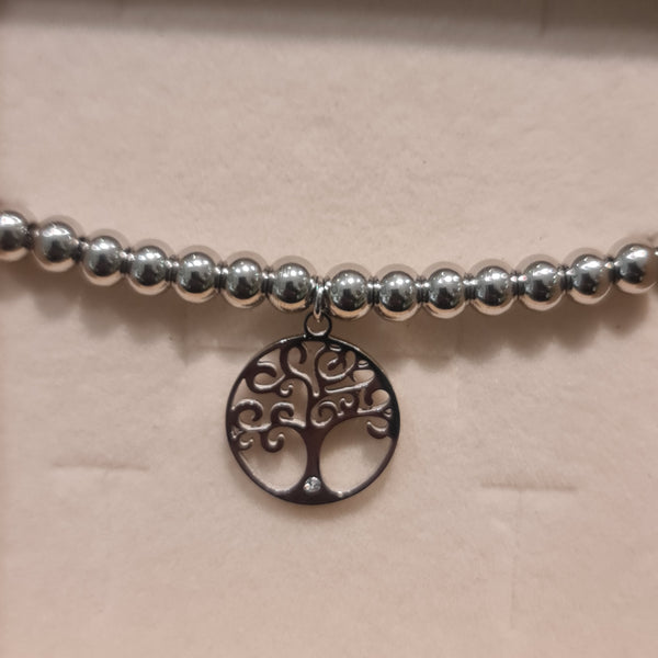 Bracelet in steel with shiny spheres and central pendant tree of life cut-out