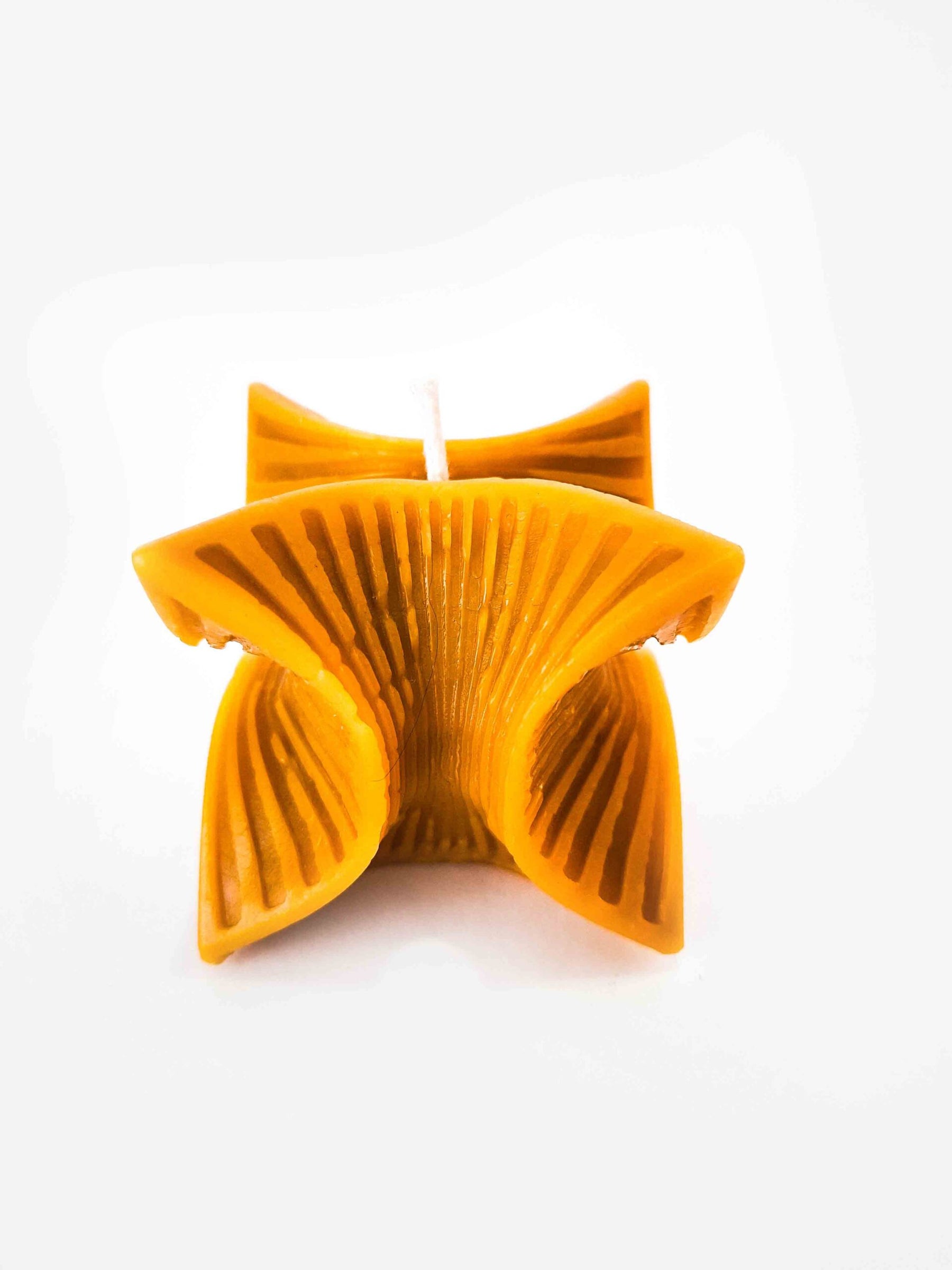 Elegant candle with fringes in a box with wood wool