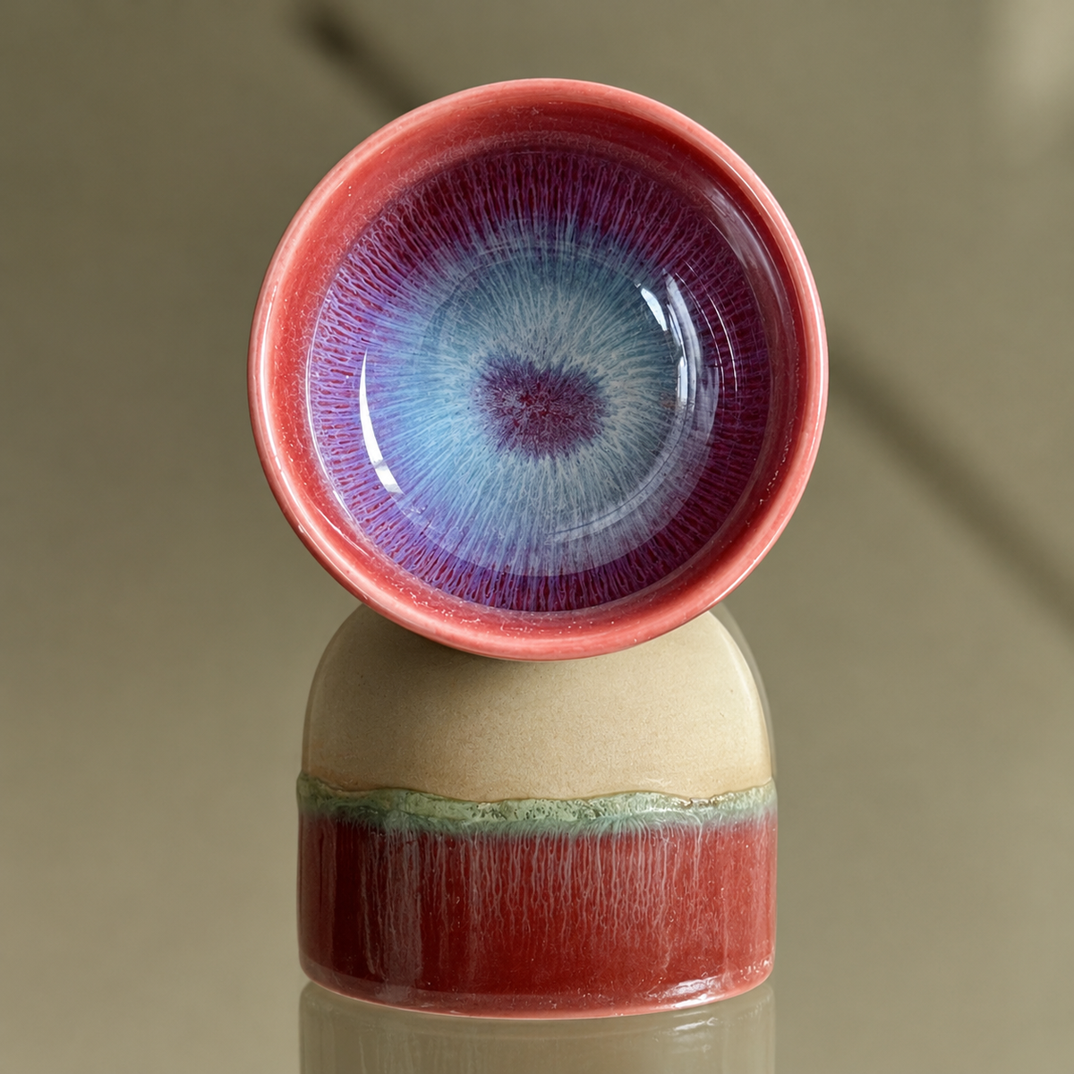 Reusable CocoBee ceramic cups with red rims and blue glazed interiors