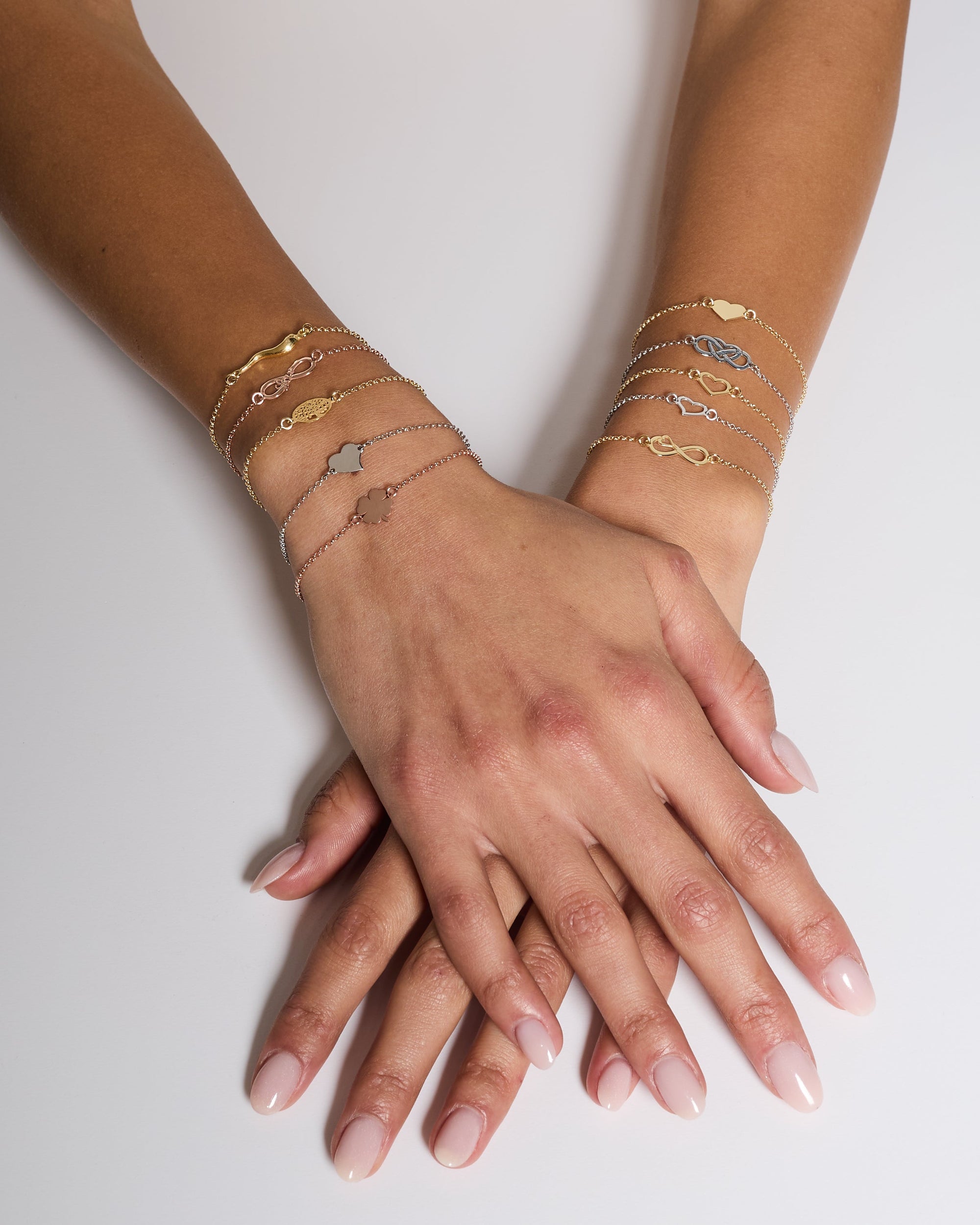 Rose gold plated silver bracelet with intertwined and perforated infinity center and heart