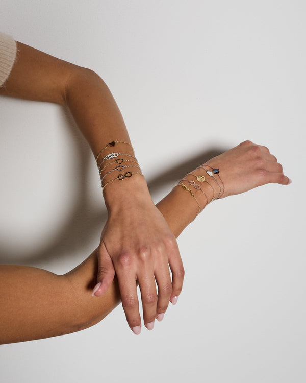 Rose gold plated silver bracelet with intertwined and perforated infinity center and heart
