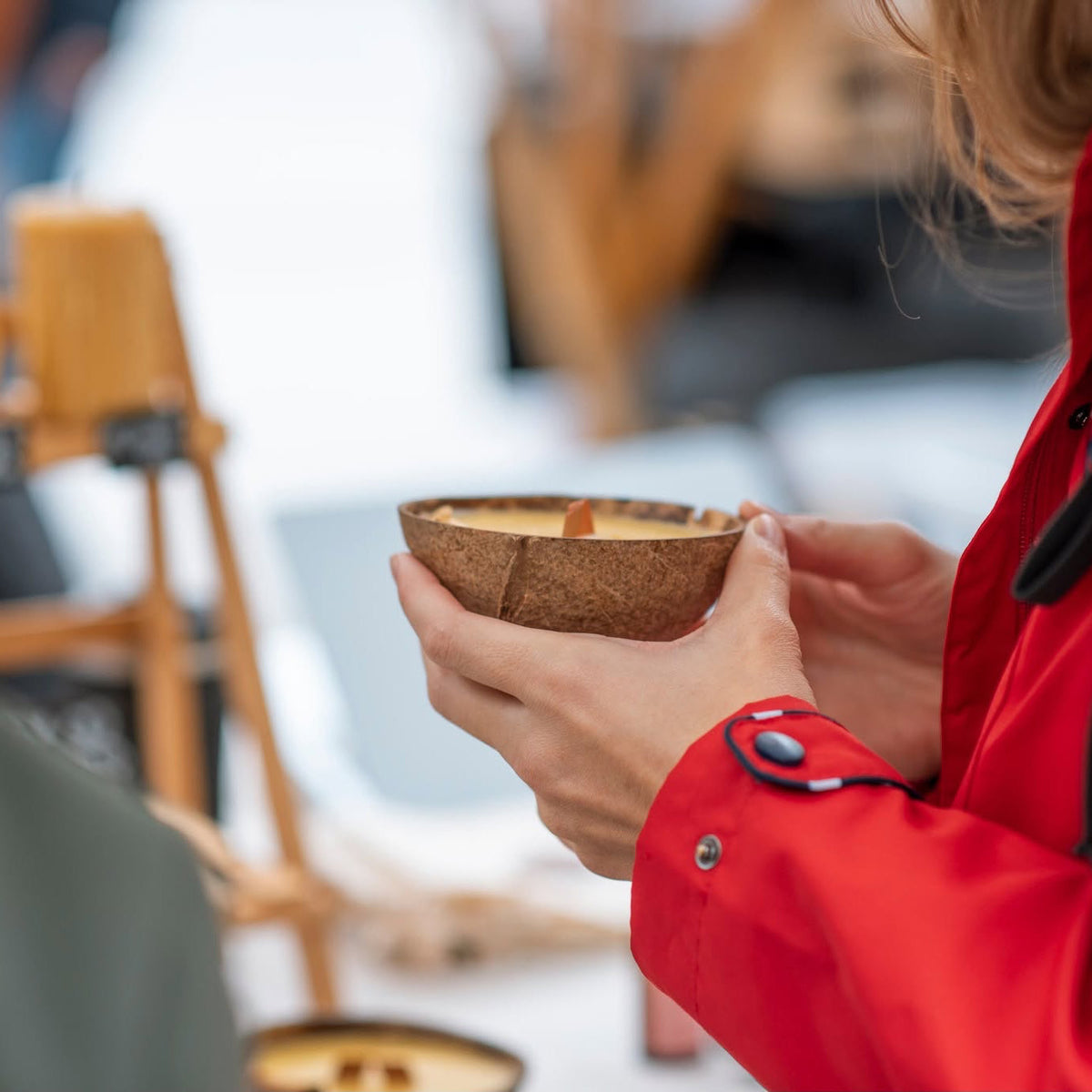 Visitor holding a CocoBee Coconut Candle at ARTish