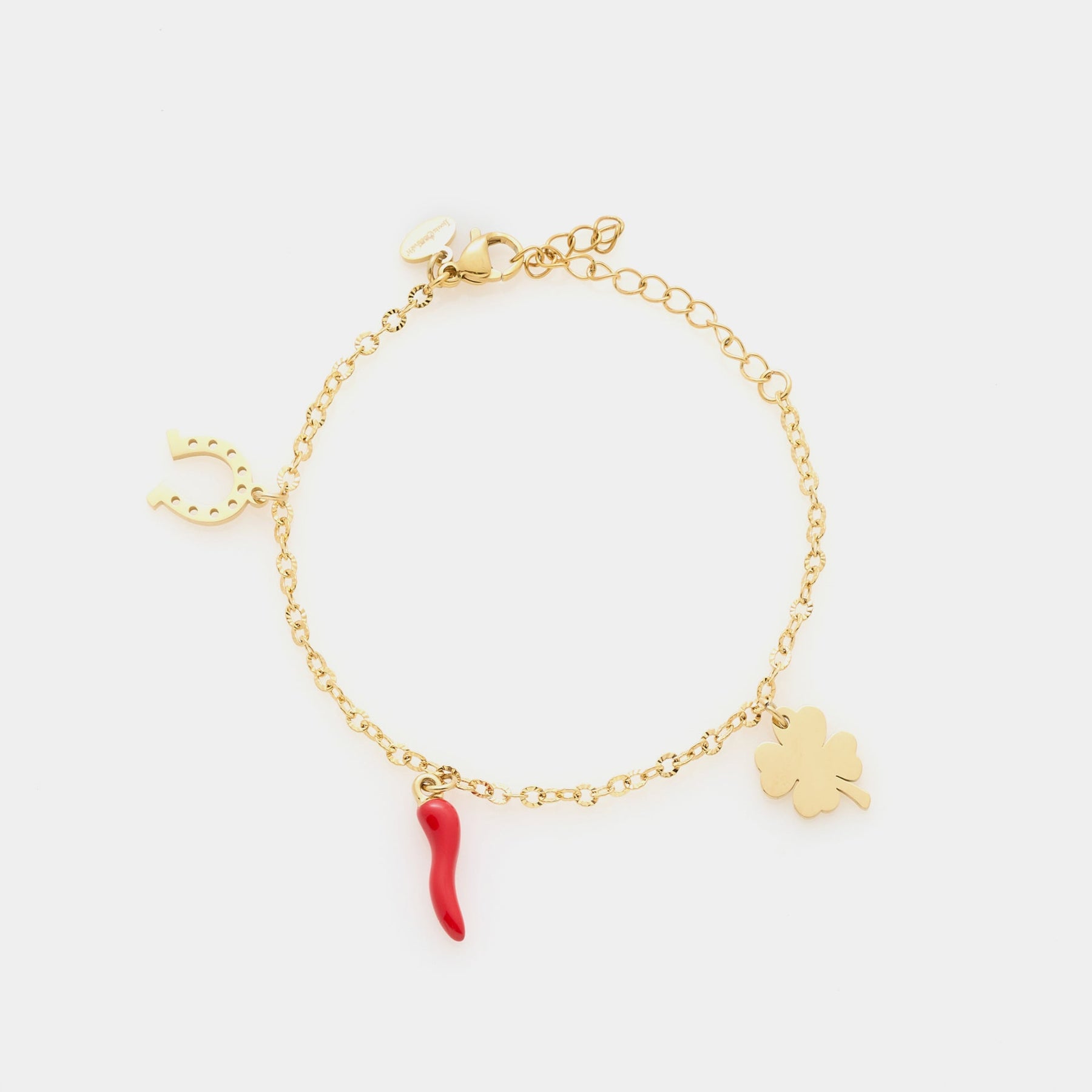Gold-plated steel bracelet with fine rolò chain and three gold-plated charms: shamrock, red enamel horn, and horseshoe