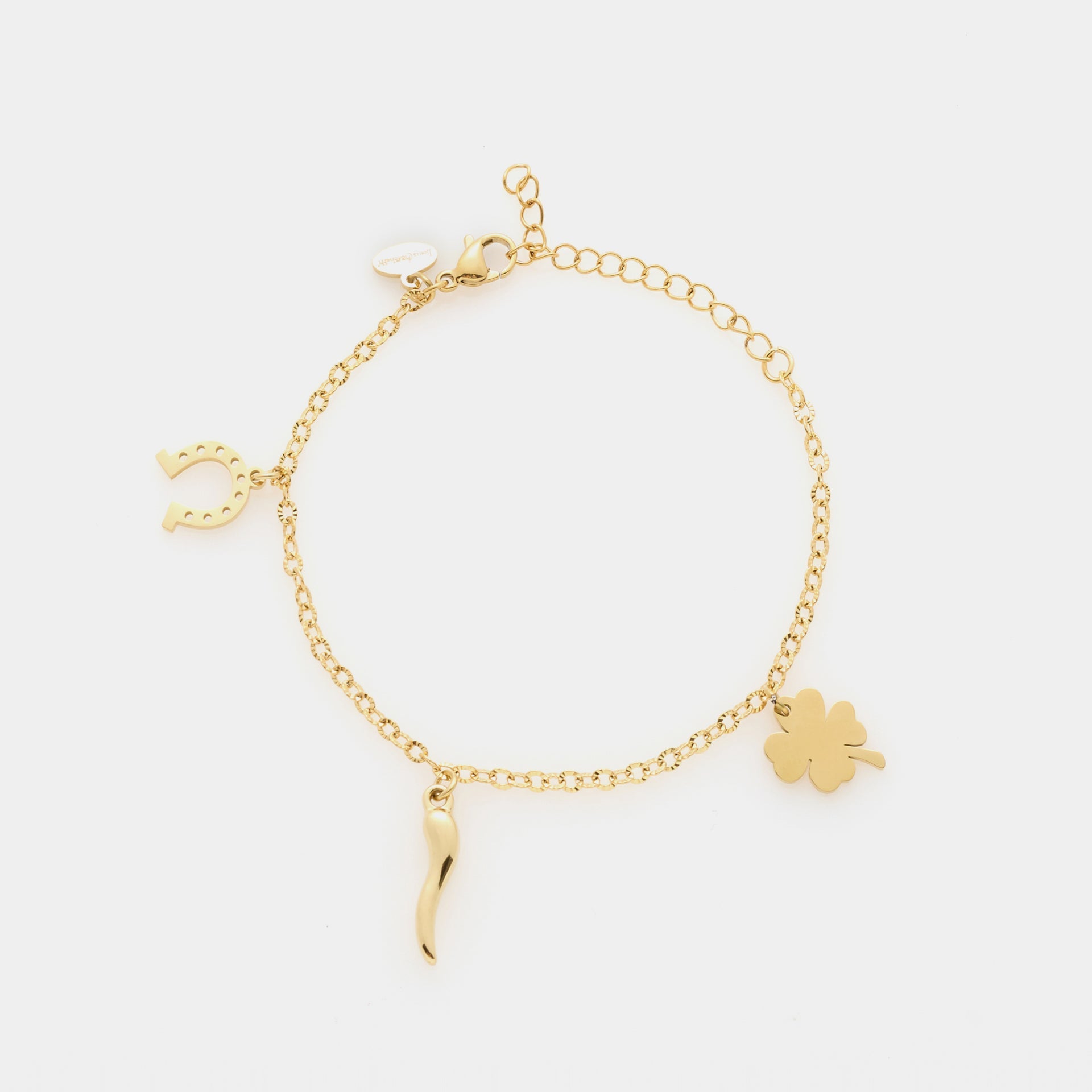 Gold-plated steel bracelet with fine rolò chain and three gold-plated charms: clover, horn, and horseshoe