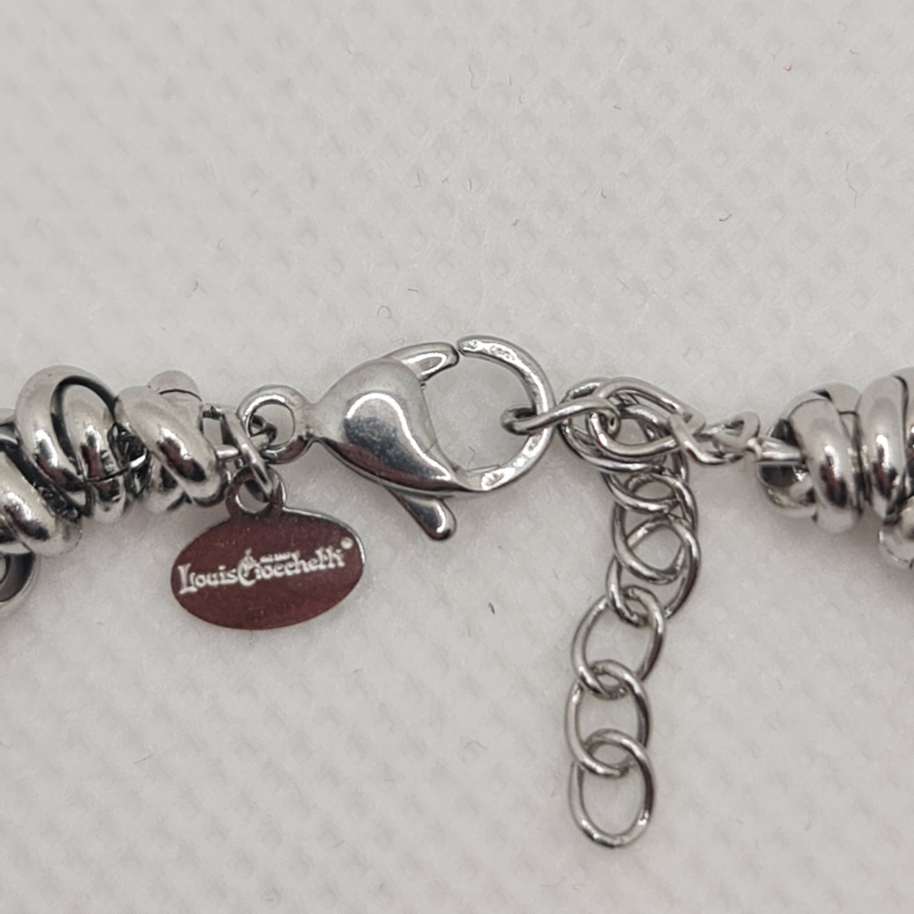 Shiny steel bracelet made of intertwined rings in the shape of knots