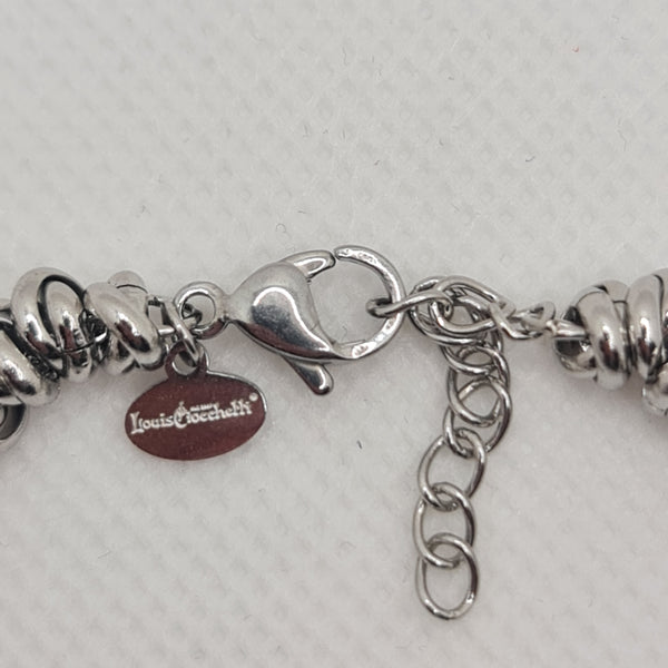 Shiny steel bracelet made of intertwined rings in the shape of knots