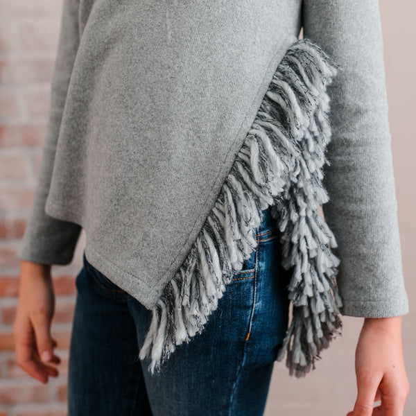 SWEATER WITH SIDE SLIT DETAIL AND FRINGE