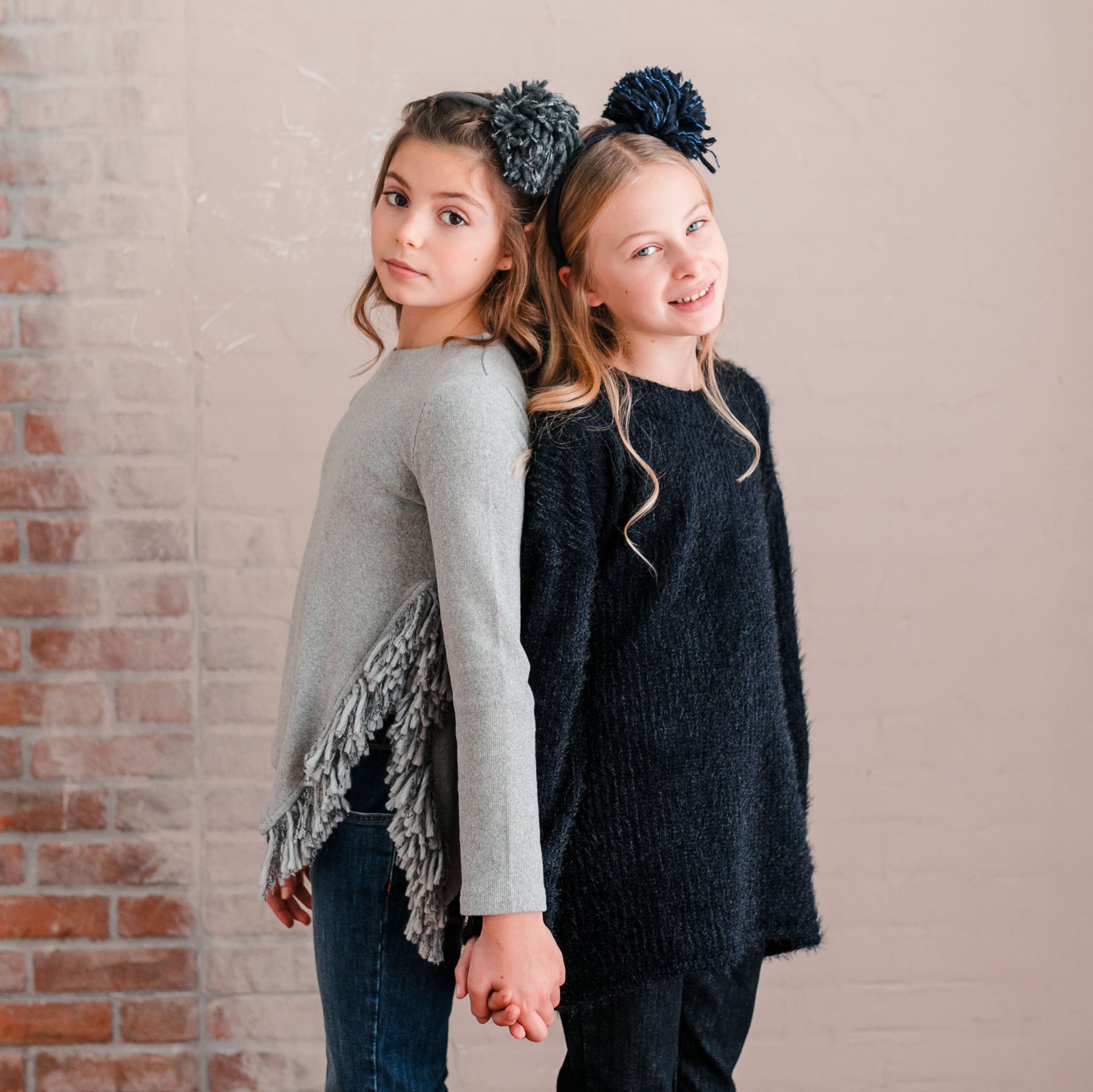 SWEATER WITH SIDE SLIT DETAIL AND FRINGE