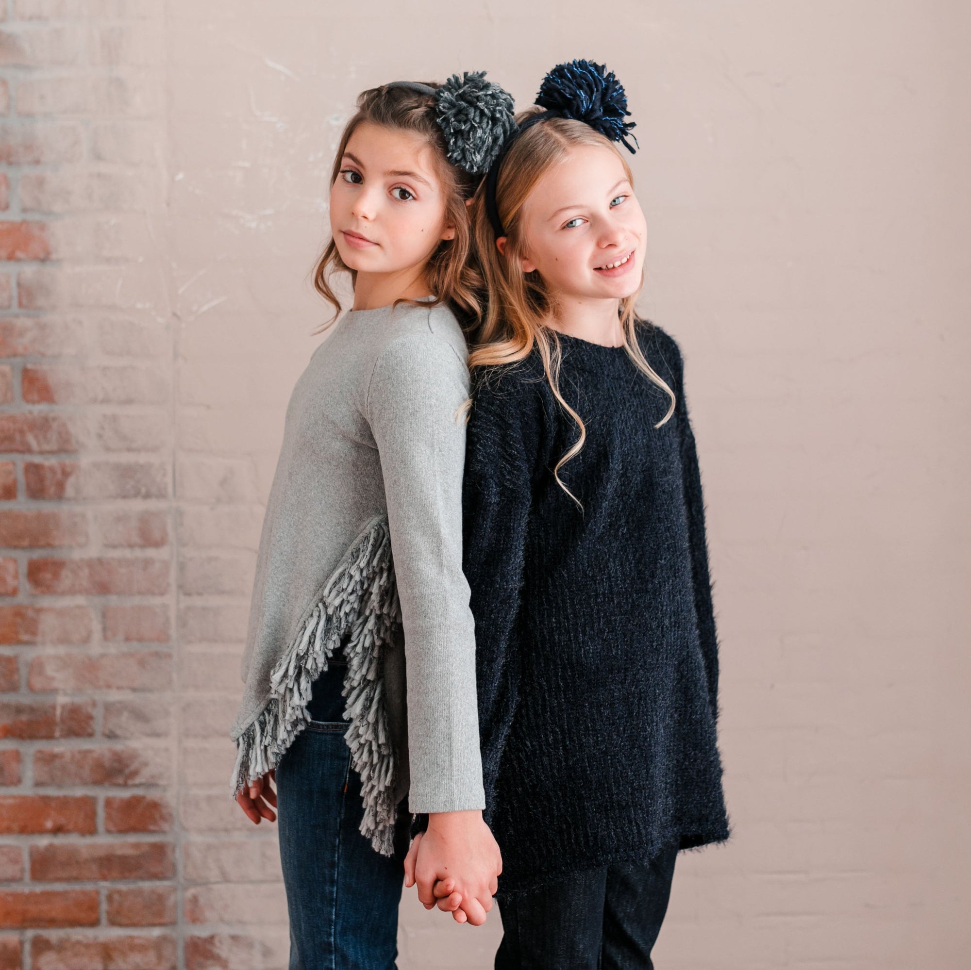 SWEATER WITH SIDE SLIT DETAIL AND FRINGE