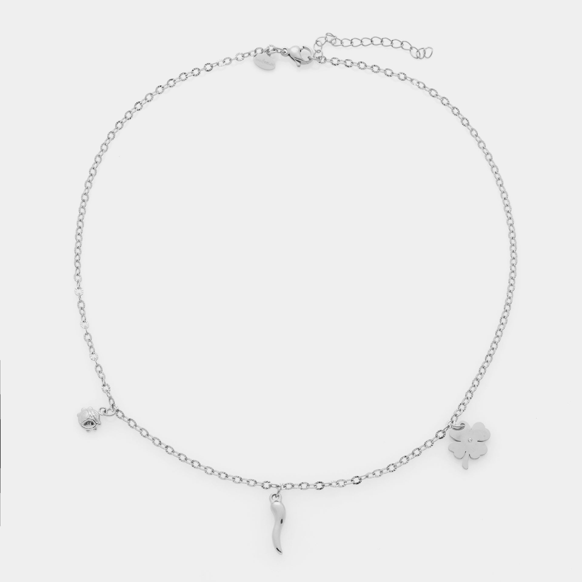 Collana acciaio maglia rolò fina con tre ciondoli in acciaio quadrifoglio, corno e coccinella
