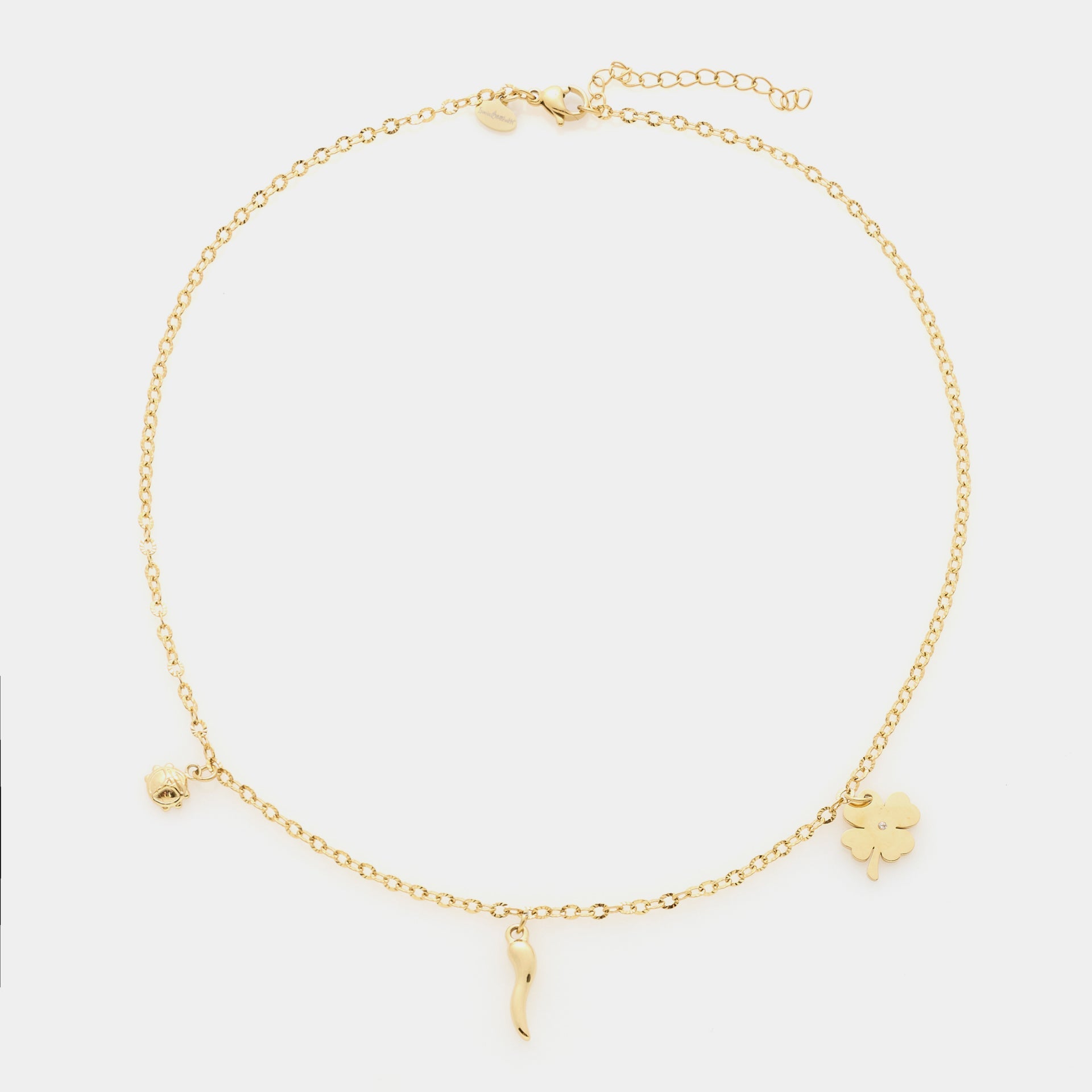 Gold-plated steel bracelet with fine rolò chain and three gold-plated steel charms: clover, horn, and ladybug