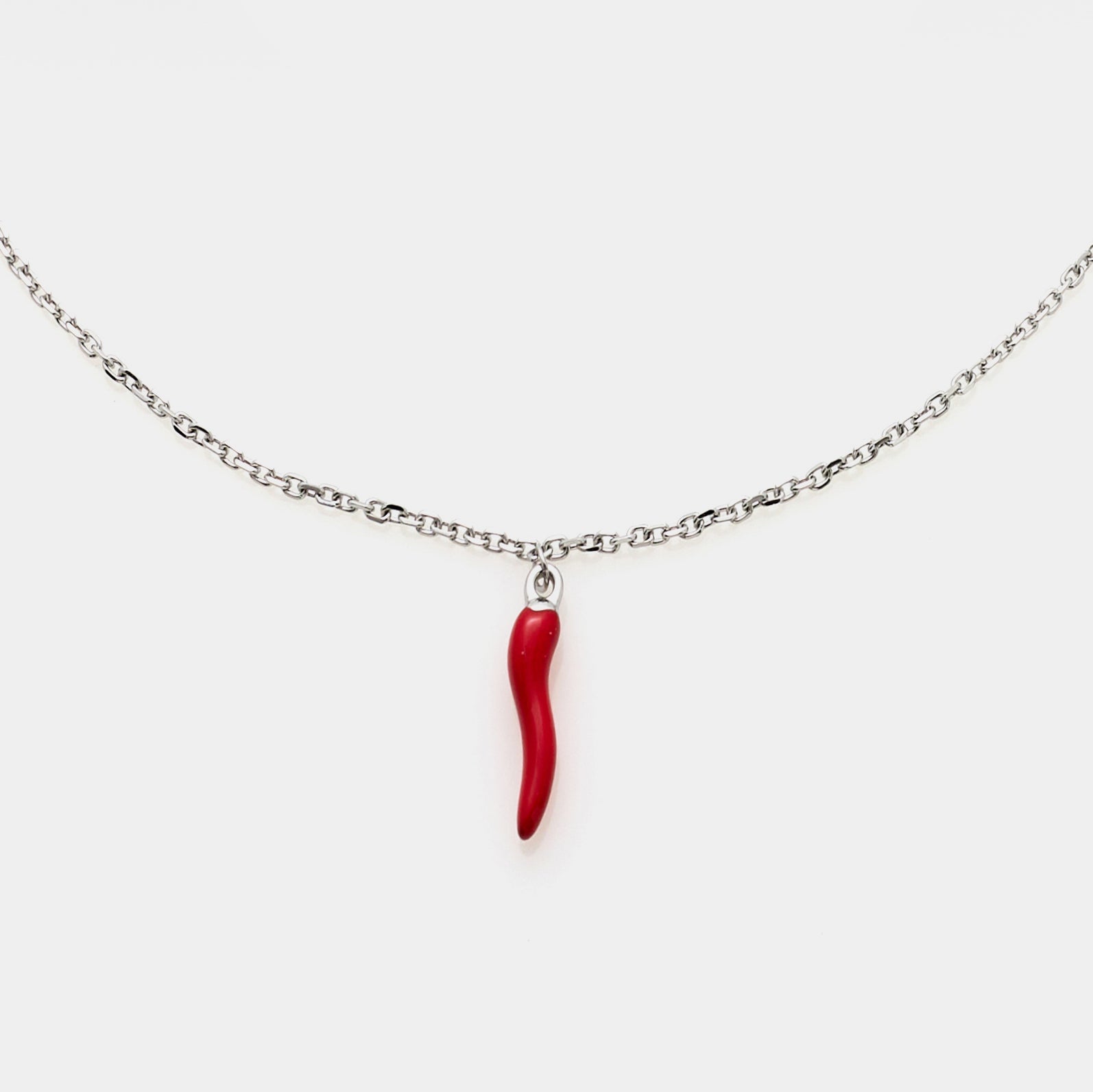 Fine steel rolo chain necklace with central red enameled steel horn pendant