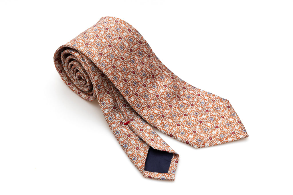 Orange tie with geometric pattern in pure silk