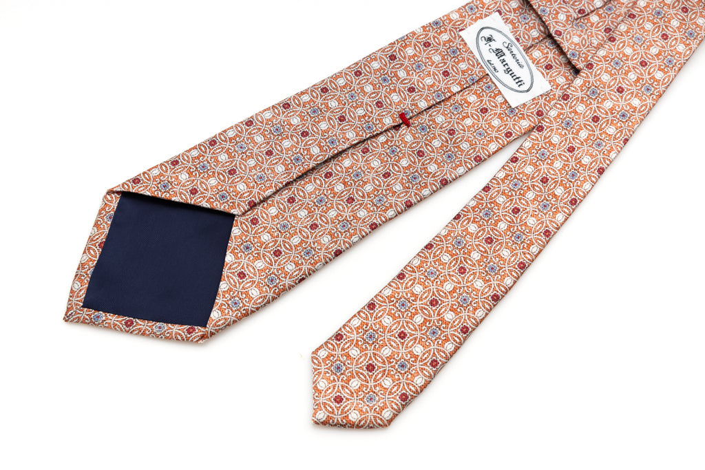 Orange tie with geometric pattern in pure silk