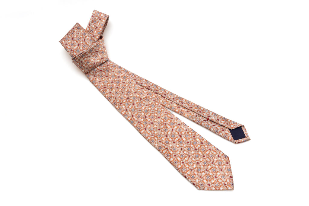 Orange tie with geometric pattern in pure silk