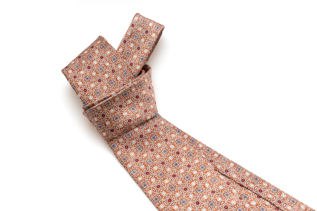 Orange tie with geometric pattern in pure silk