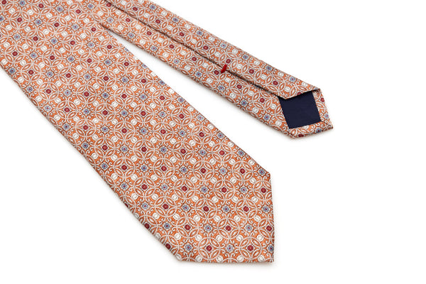 Orange tie with geometric pattern in pure silk
