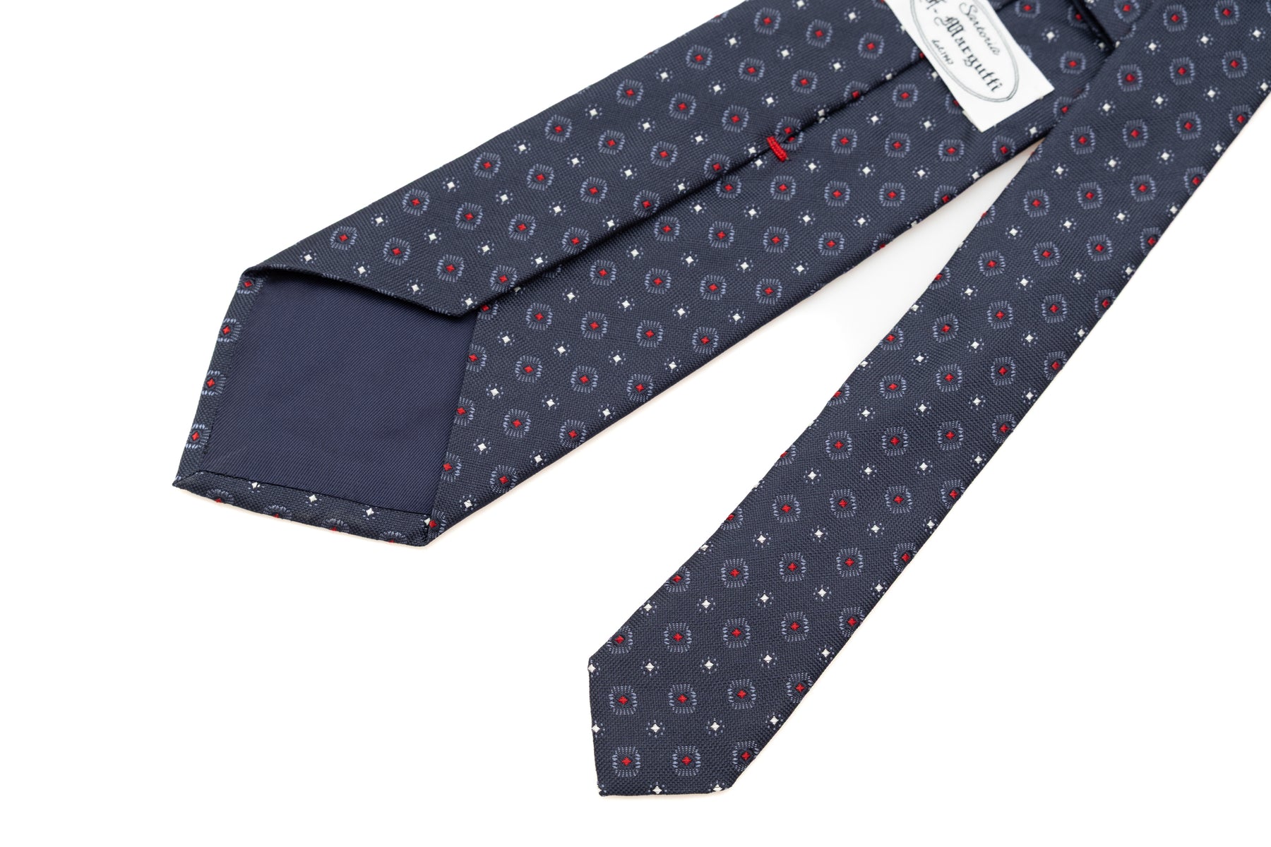 Cravate bleue avec motif rouge en pure soie