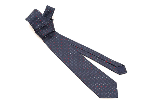 Cravate bleue avec motif rouge en pure soie