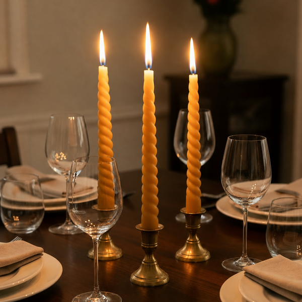 CocoBee beeswax dinner candles on a warmly set dining table
