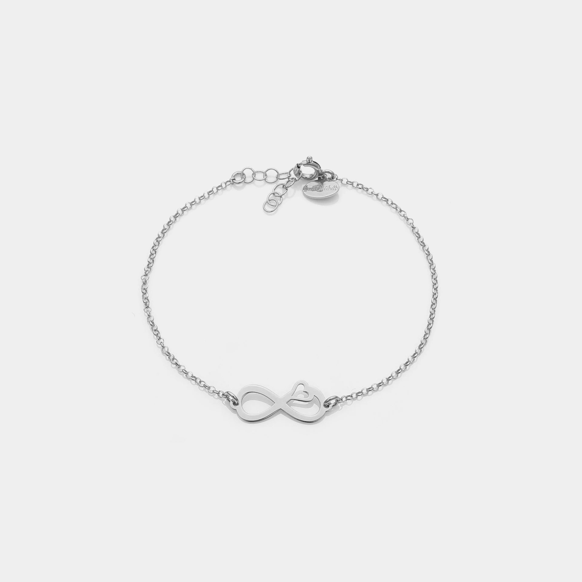 Rhodium-plated silver bracelet with pierced infinity center and side heart