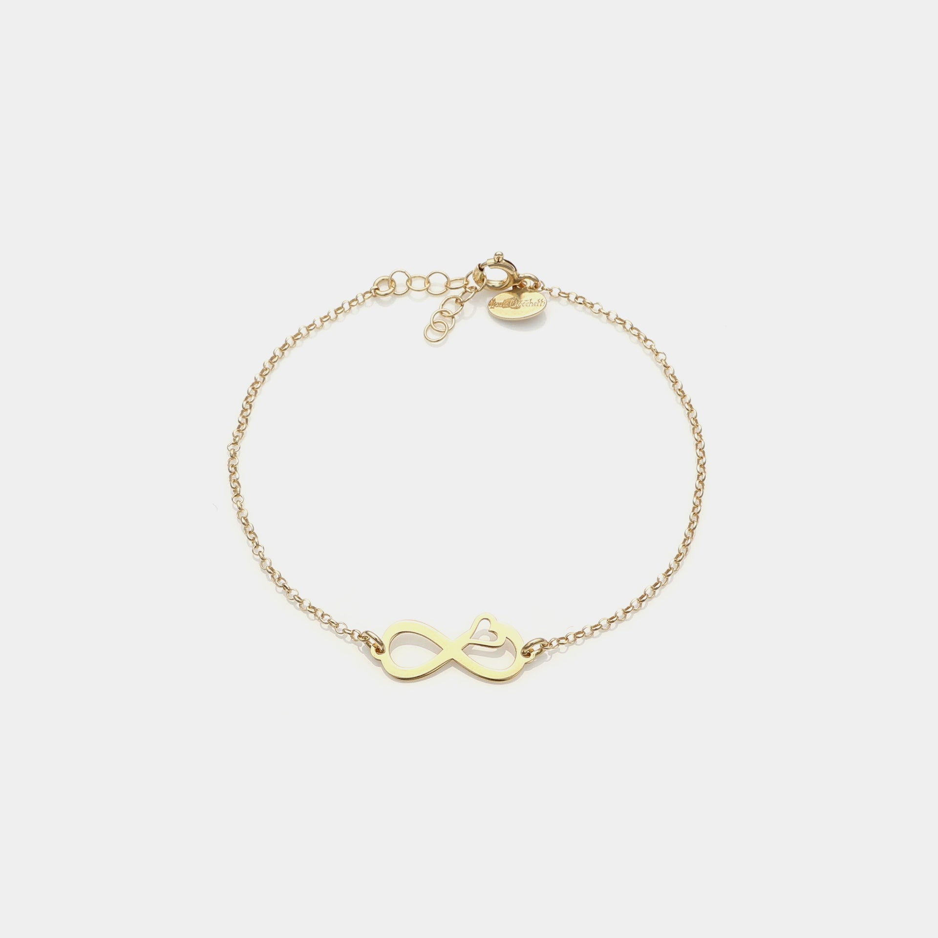 Gold-plated silver bracelet with pierced infinity center and side heart